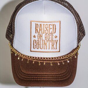 Brown and white "Raised on 90's Country" hat with hat jewelry